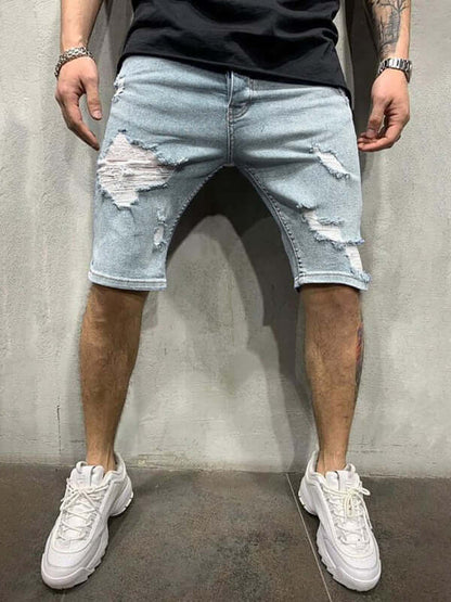 Man wearing Averra Ripped Short Jeans with oversized fit, styled for streetwear fashion and paired with white sneakers.